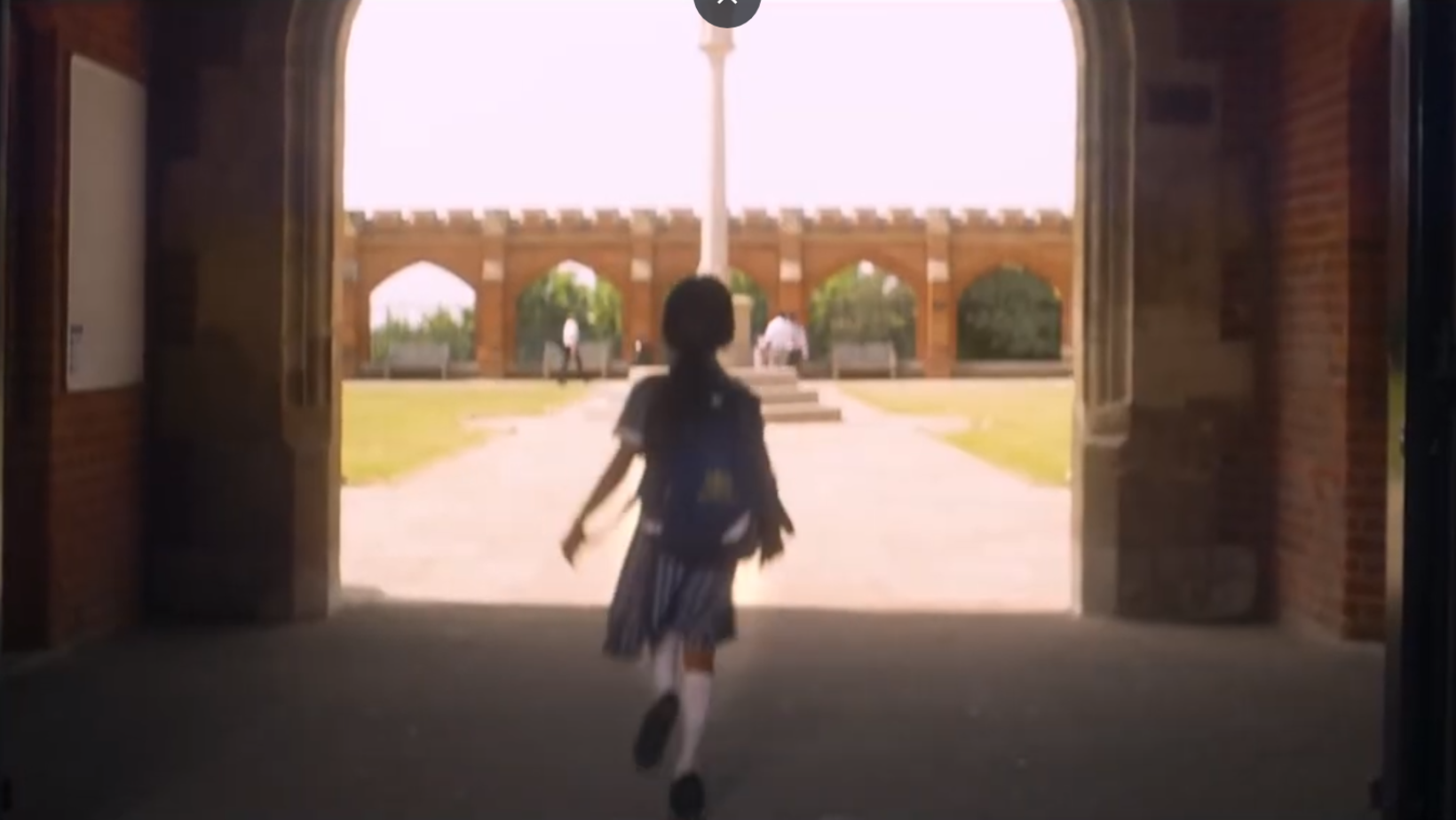 girl running into school